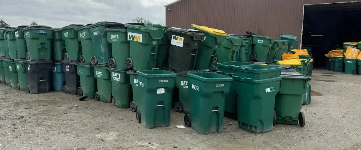 Large row of commercial trash bins ready for cleaning