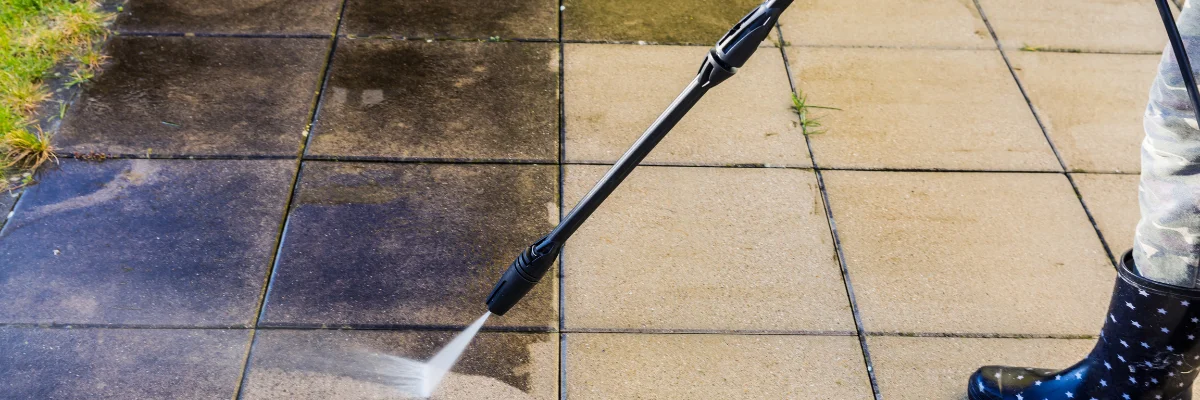 High-pressure water jet cleaning concrete pavement.