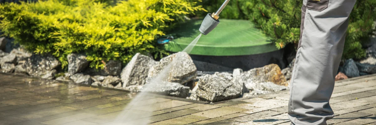 Close-up of pressure washer cleaning wooden deck boards.