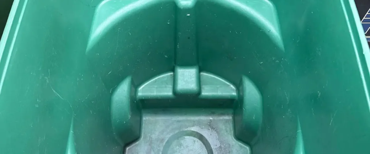 A close-up, high-angle view of the textured, molded interior of a green plastic boat or kayak, showing slight wear. A close-up, high-angle view of the textured, molded interior of a green plastic boat or kayak, showing slight wear.