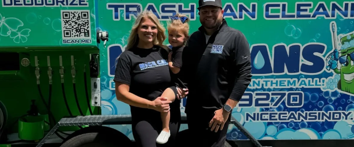 A smiling family of three, parents holding a small child, stand proudly in front of a 'Nice Cans' trash cleaning truck. A smiling family of three, parents holding a small child, stand proudly in front of a 'Nice Cans' trash cleaning truck.