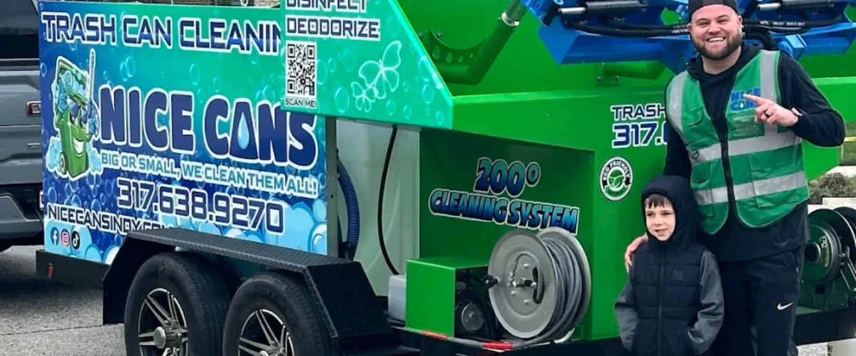 A close-up of a green sanitizing machine with blue hydraulic arms emitting a fine mist, parked on a sunny day. A close-up of a green sanitizing machine with blue hydraulic arms emitting a fine mist, parked on a sunny day.