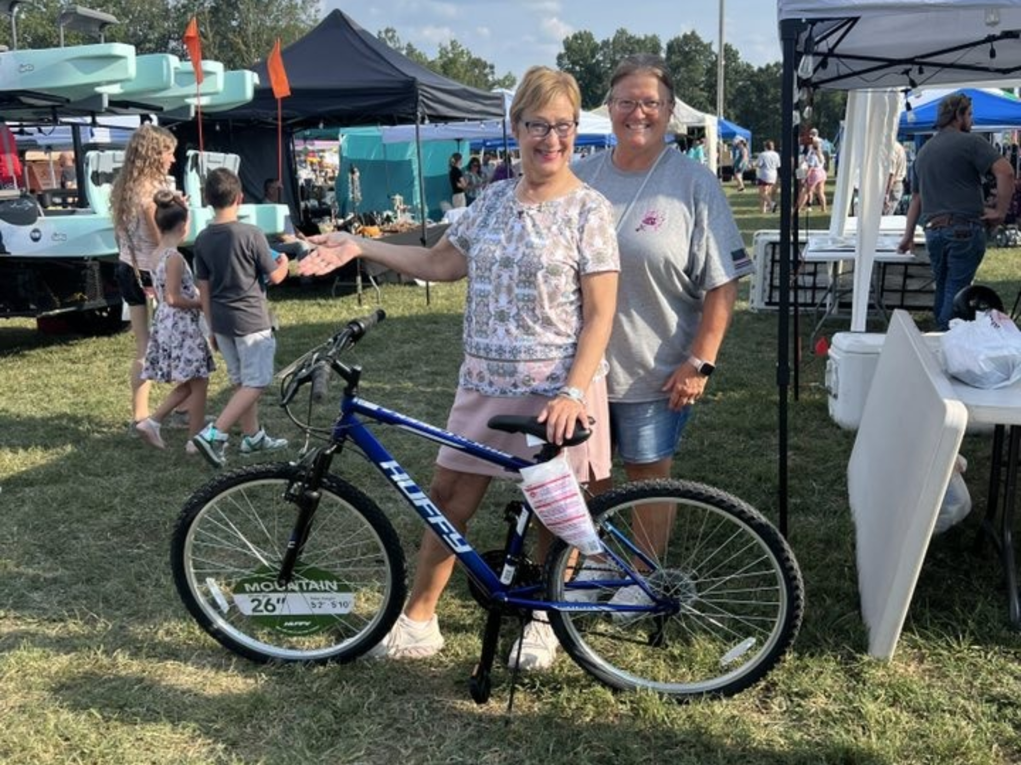 Two kids with new bikes, big smiles