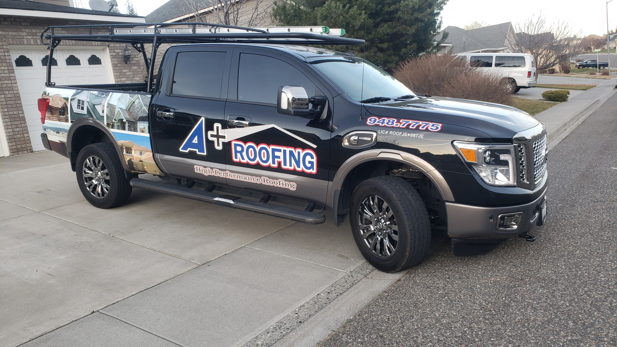 A+ Roofing service truck on site at a completed roofing project in the Tri-Cities, Washington
