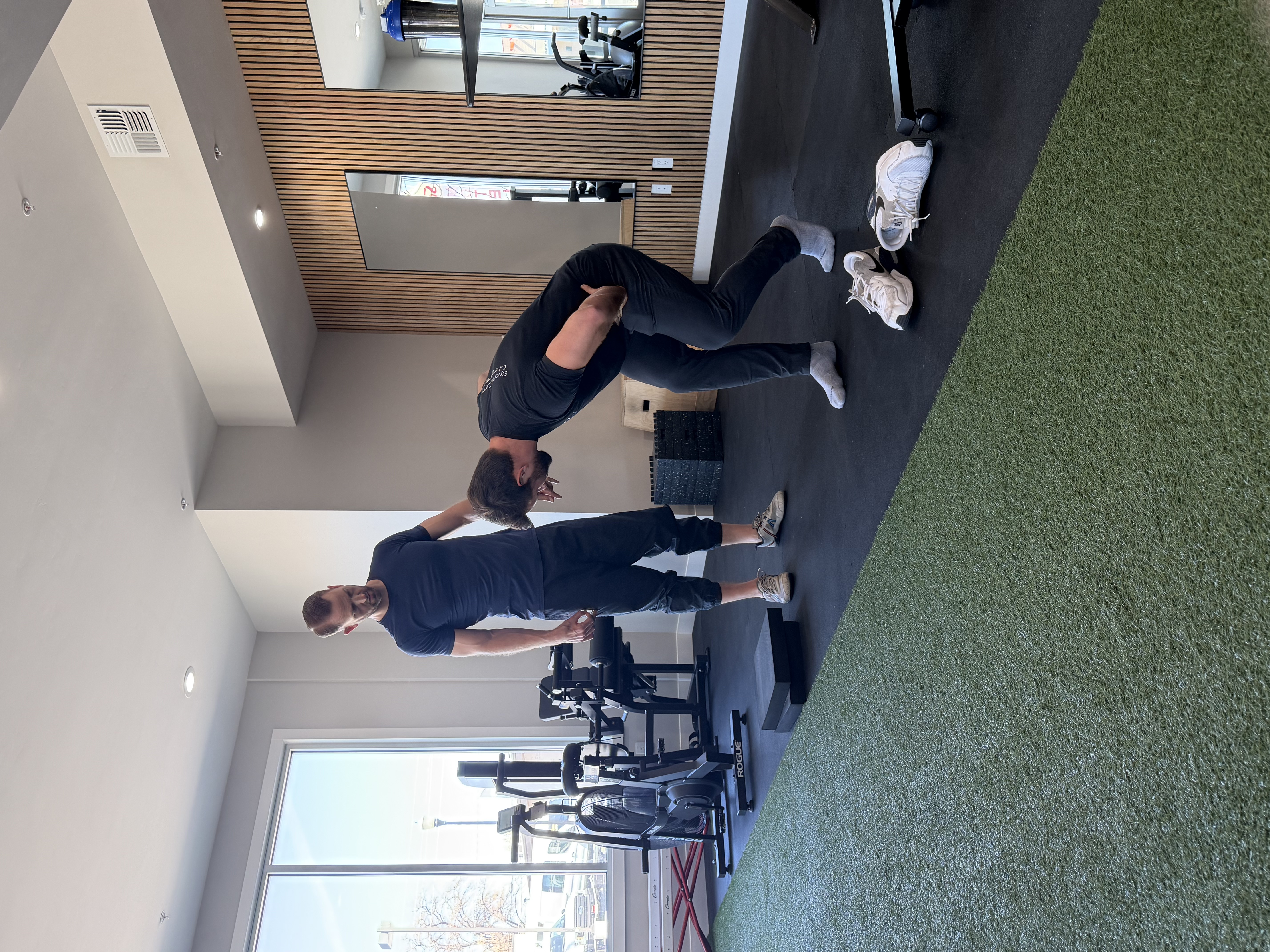 Dr. Alex coaching a patient through rehab exercise