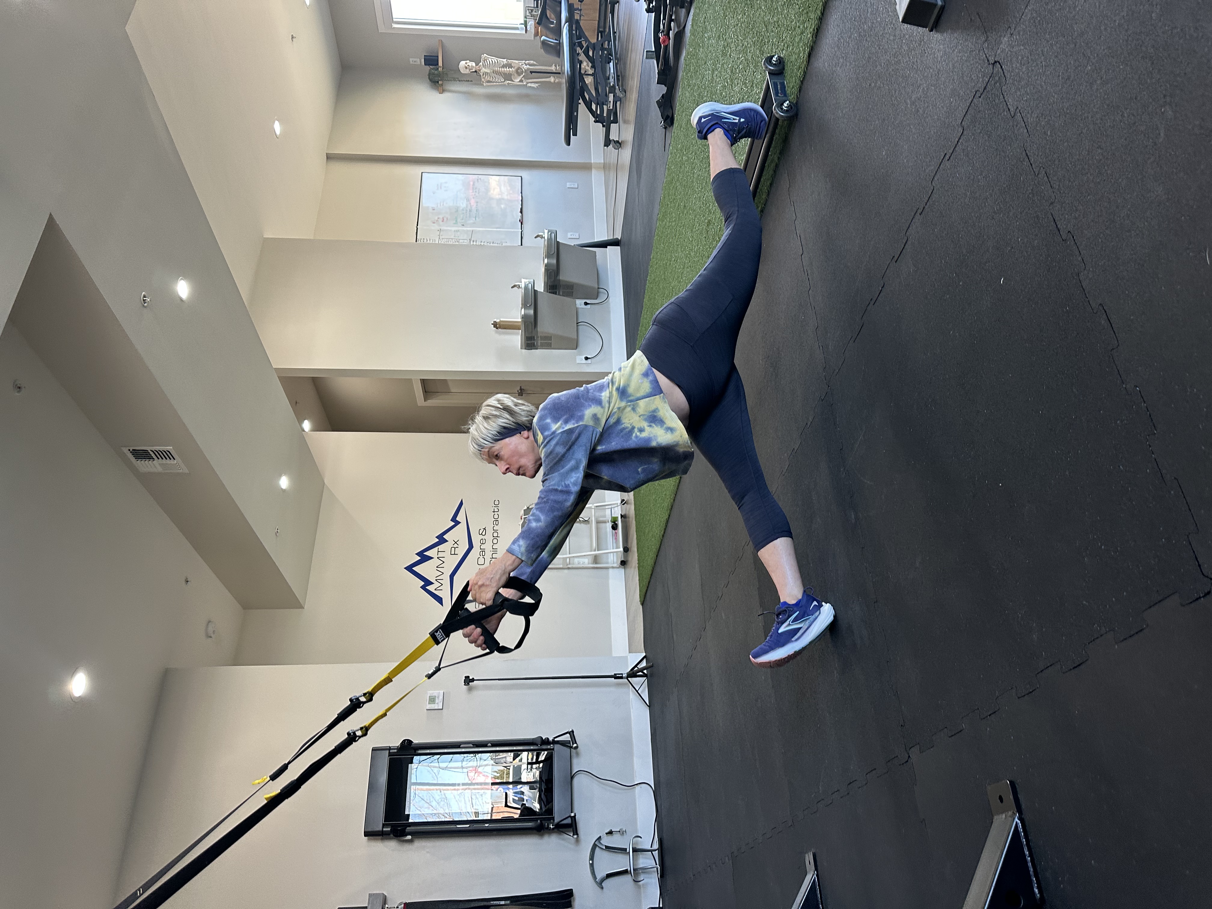 Mary, age 72, performing an advanced exercise at MVMT Rx in Reno