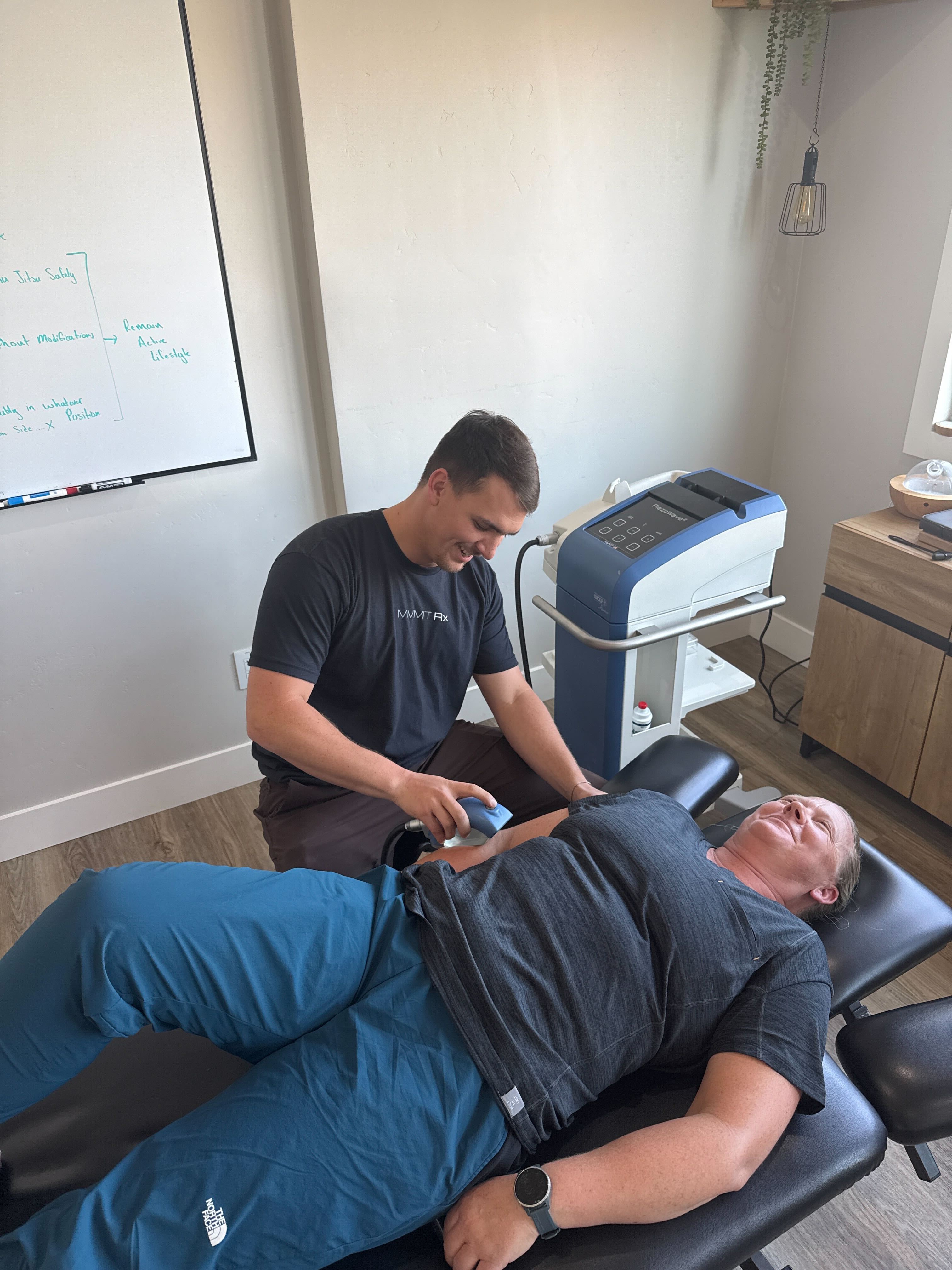 Dr. Mike performing focused shockwave therapy on a patient with PiezoWave 2 at MVMT Rx in Reno, NV
