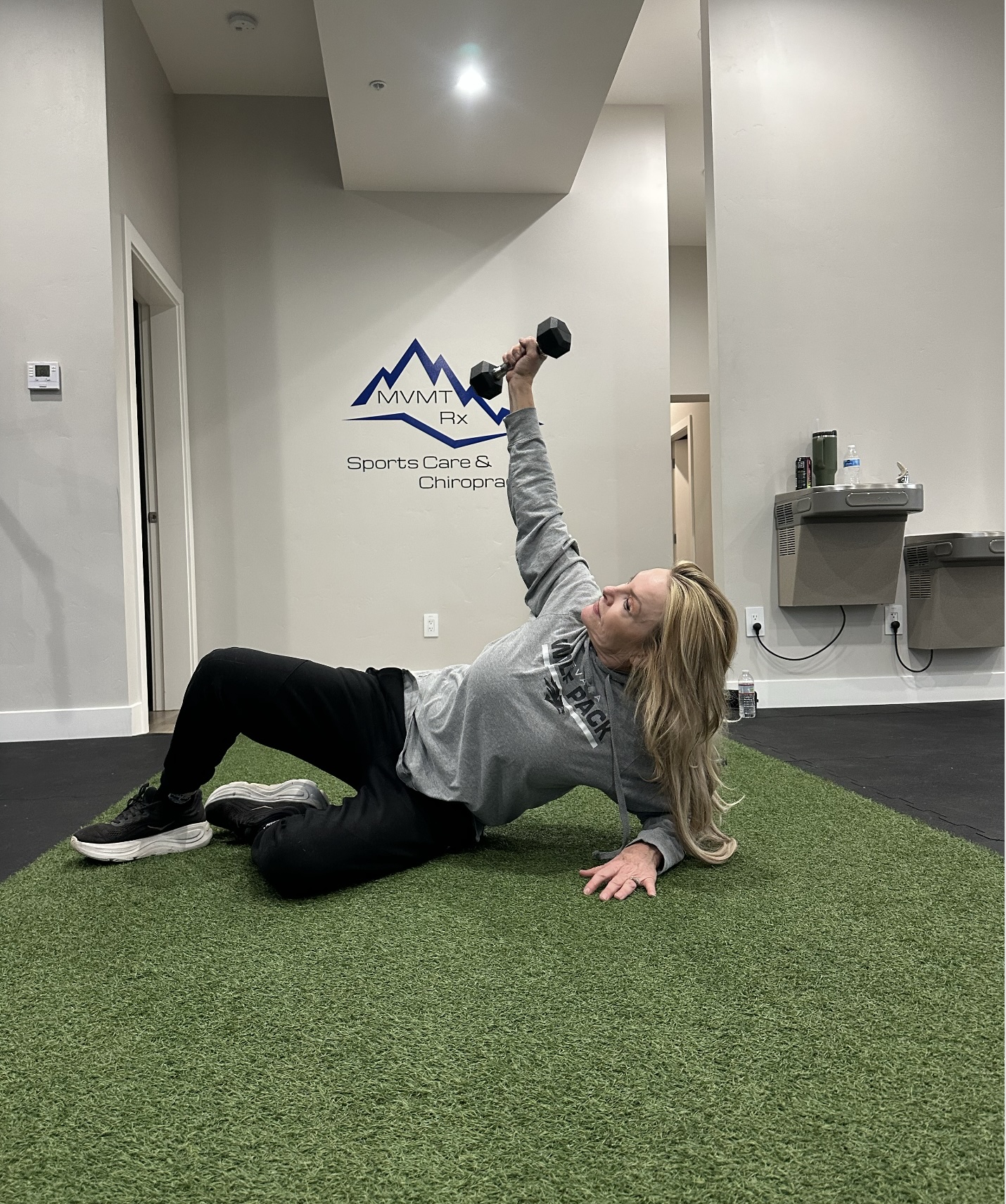 Patient performing loaded overhead dumbbell exercise during shoulder rehab Integration phase at MVMT Rx Sports Care and Chiropractic in Sparks Nevada