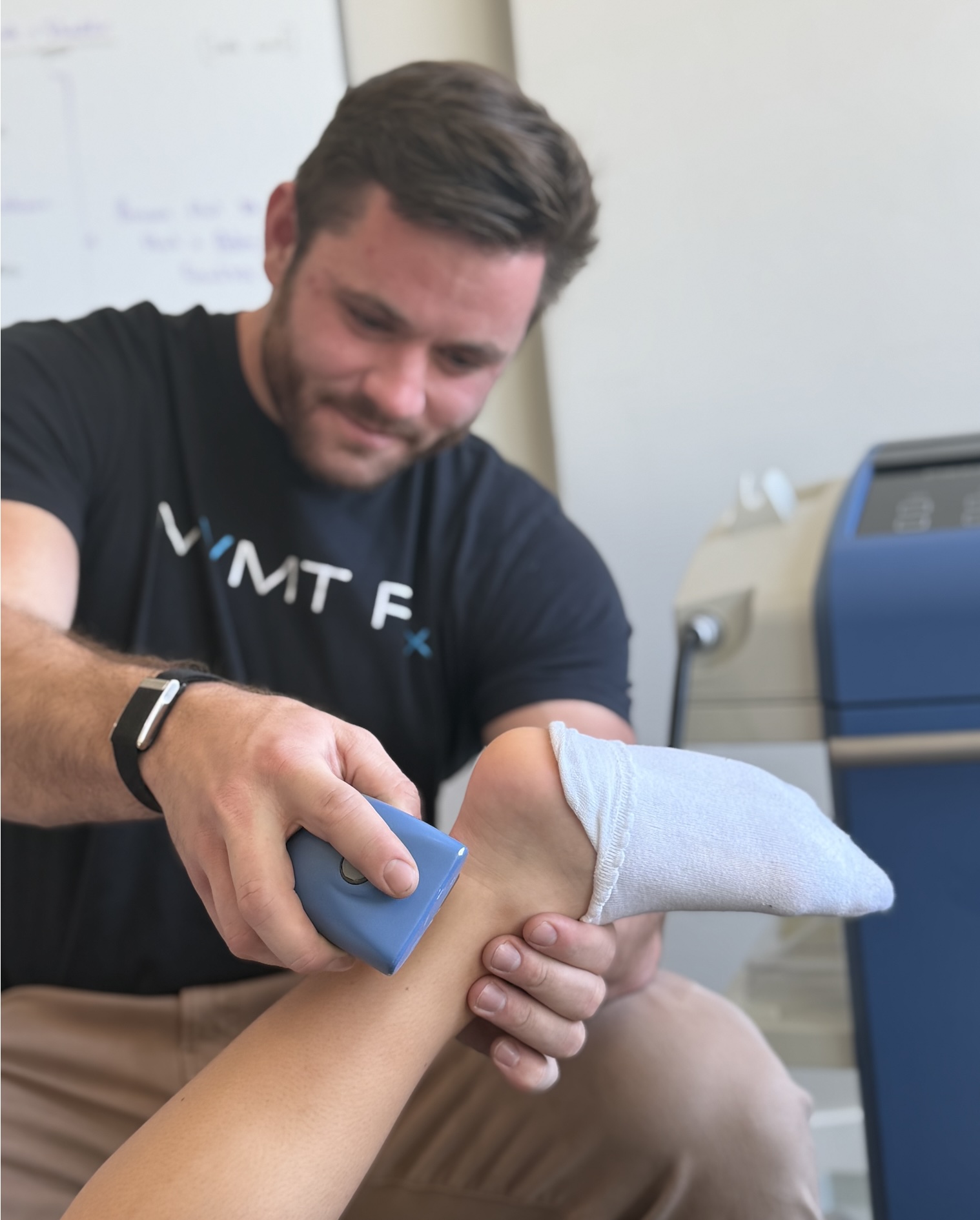 Focused shockwave therapy being applied to the Achilles tendon at MVMT Rx Sports Care and Chiropractic in Sparks NV