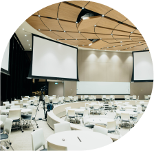 Conference room setup with circular seating arrangement, large screens, and modern lighting, suitable for virtual assistant training and organizational meetings.