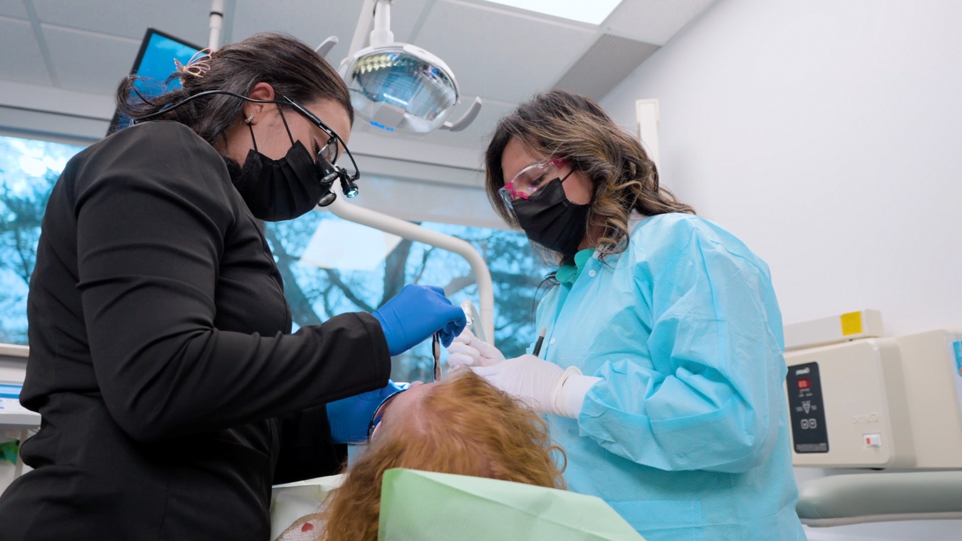 Dental professionals treating a patient during a dental procedure in a modern clinic