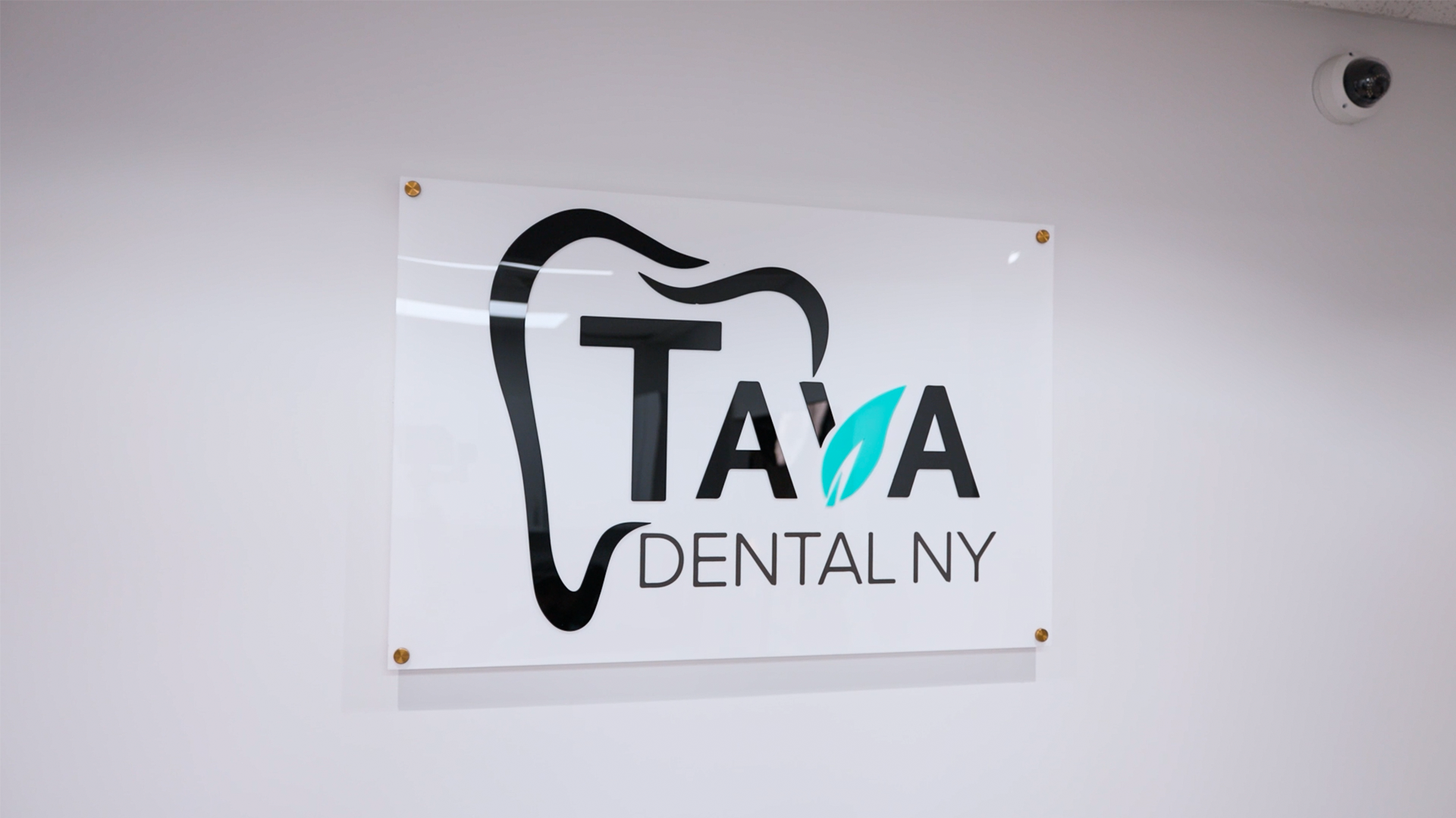 Clear aligner held in hand representing Invisalign treatment for discreet teeth straightening and improved smile appearance