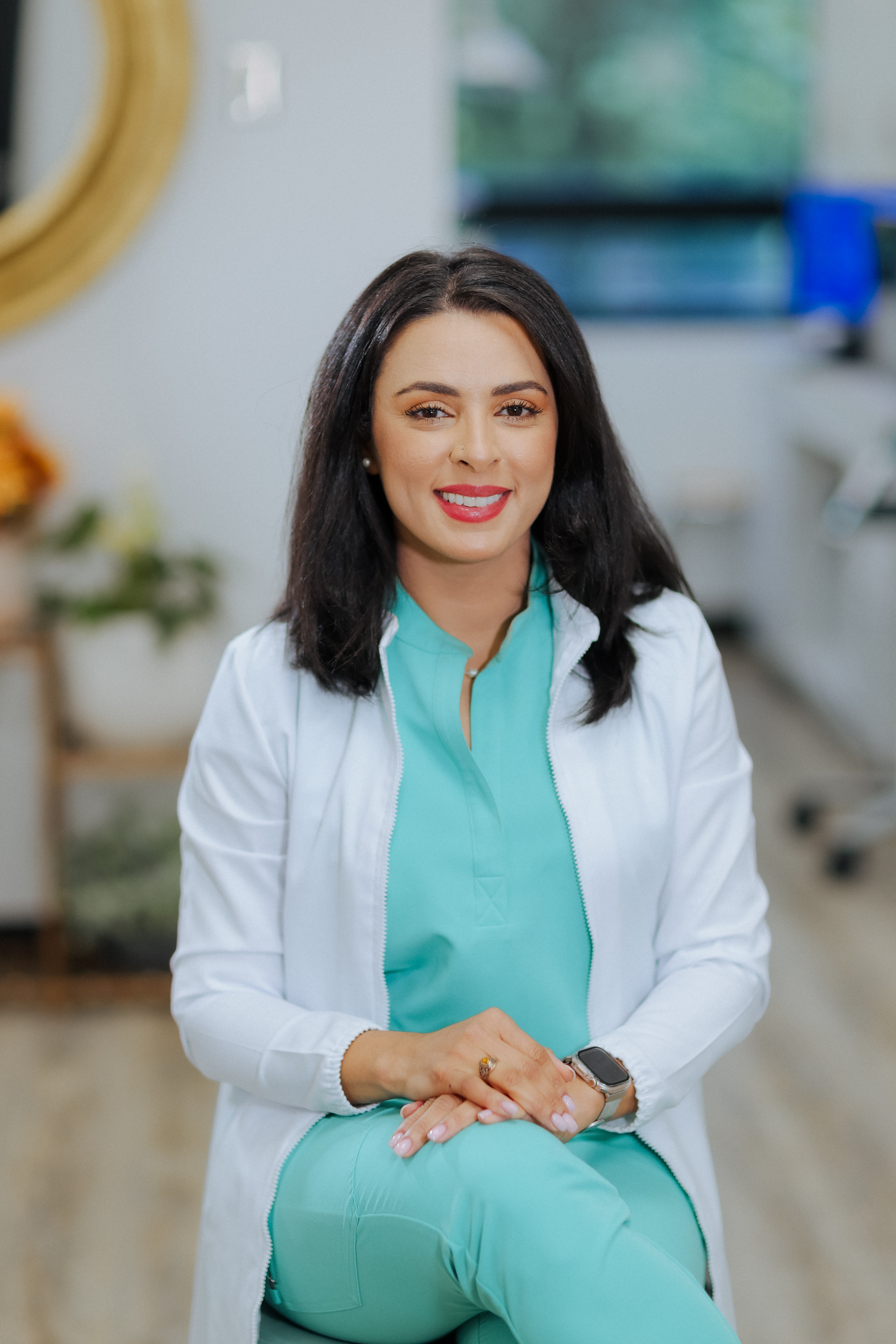 Female dentist portrait wearing lab coat representing professional expertise and approachable patient focused care delivery
