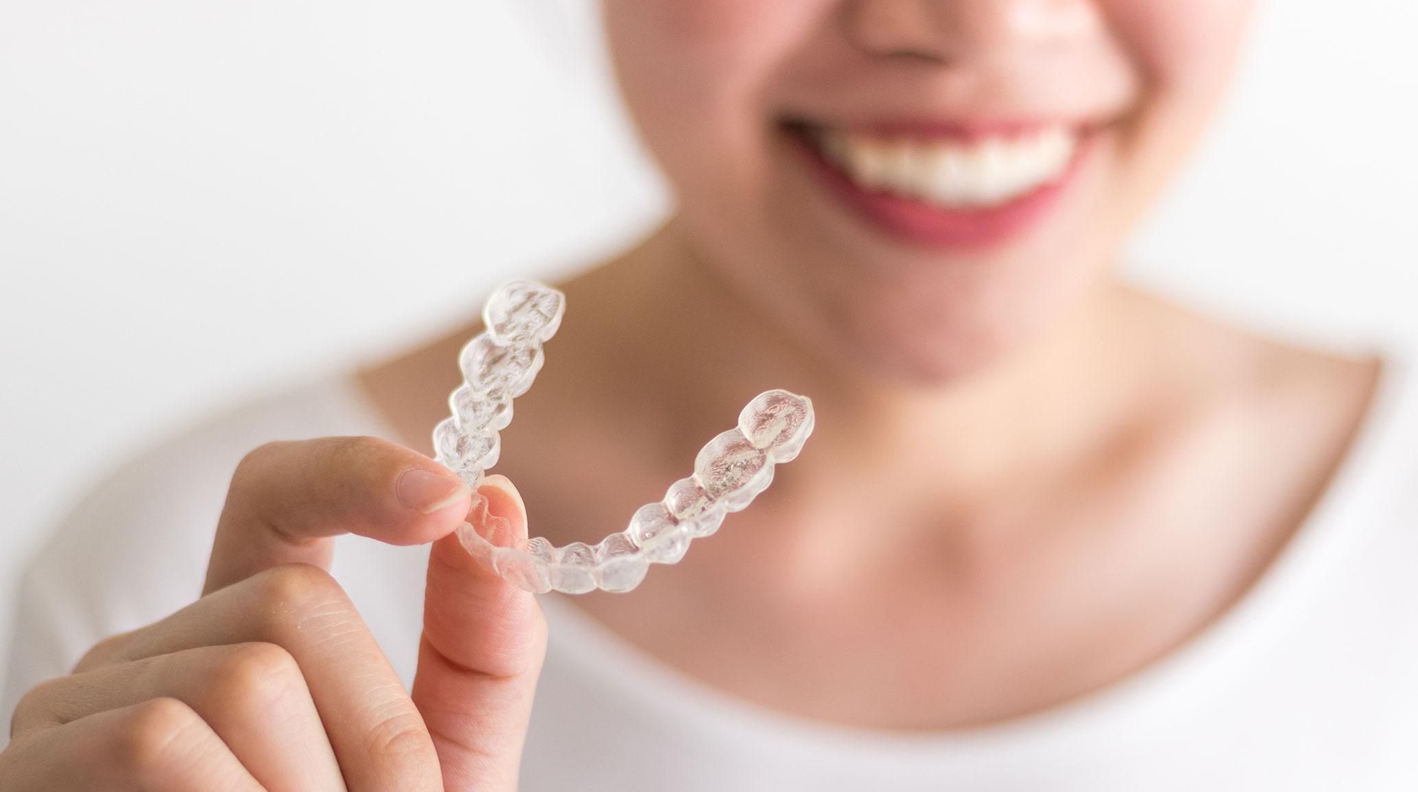 Woman holding invisalign