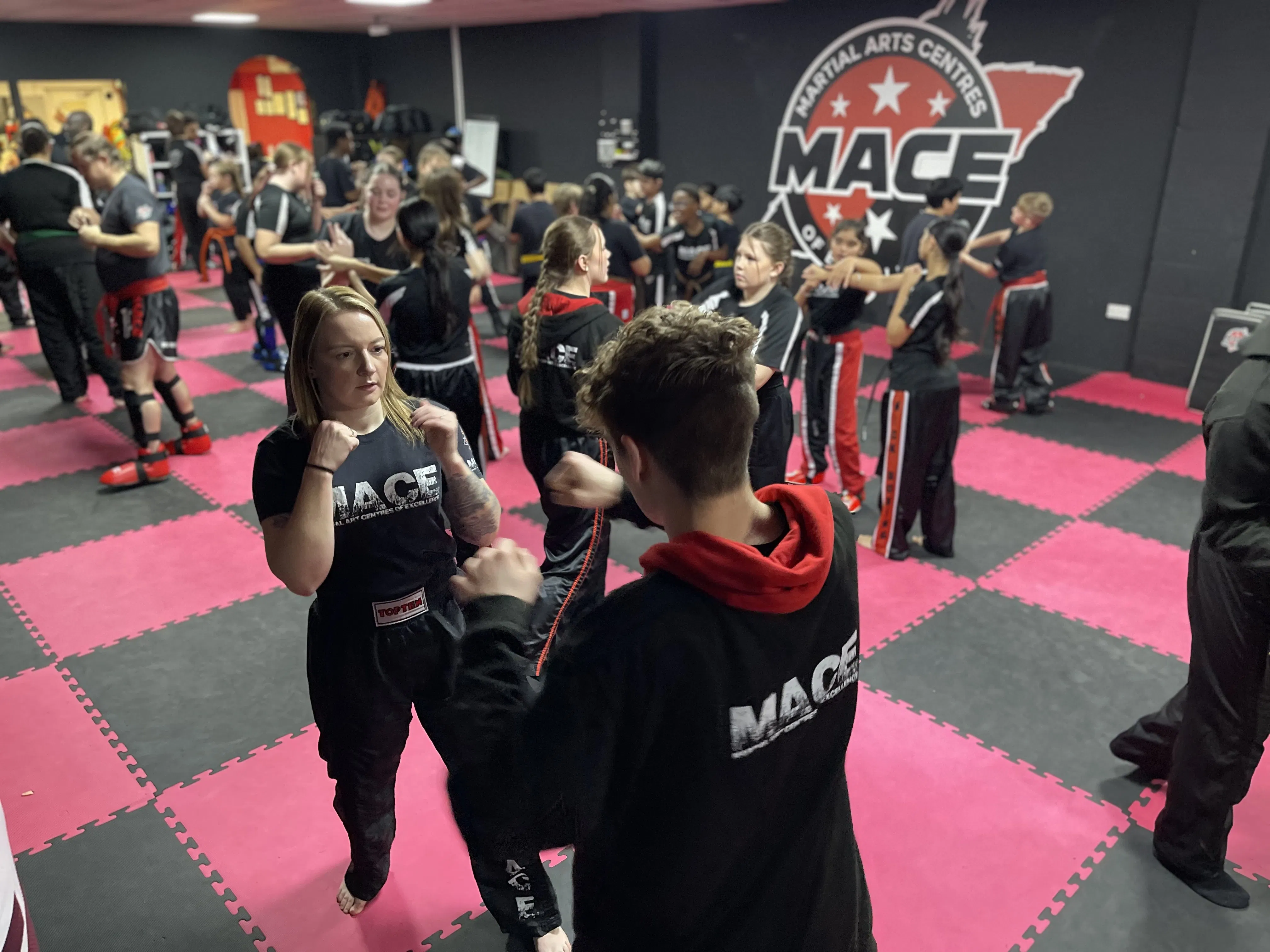 Teen martial arts students training in a structured MACE class