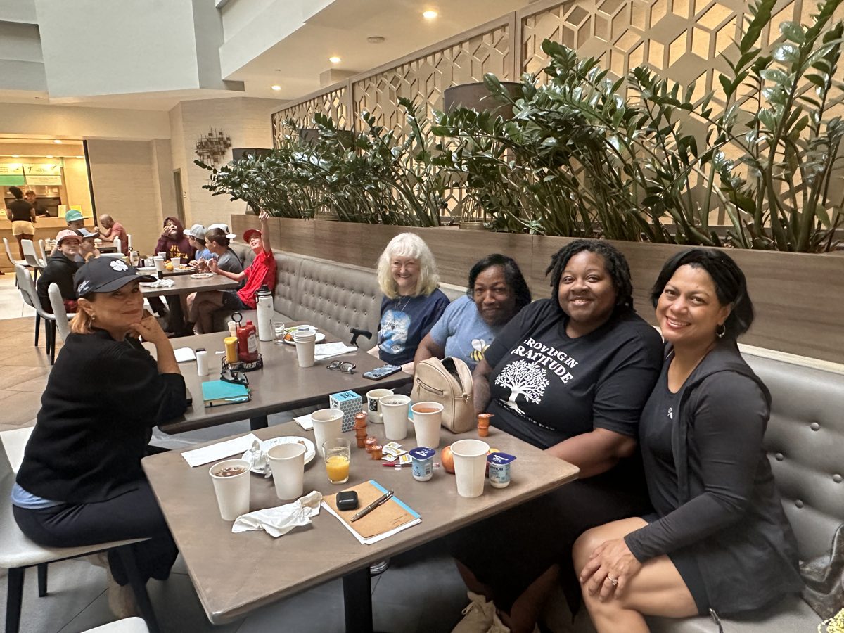 Attendees smiling together at World Gratitude Day