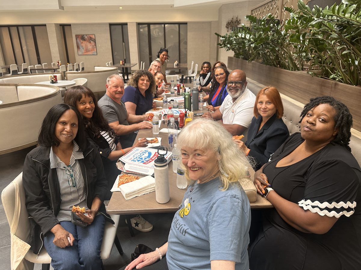 Group gathered around a table, smiling together