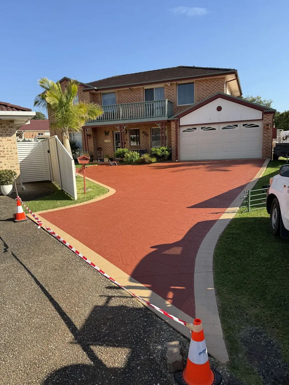 Restored concrete driveway after professional cleaning and colour sealing in Figtree NSW