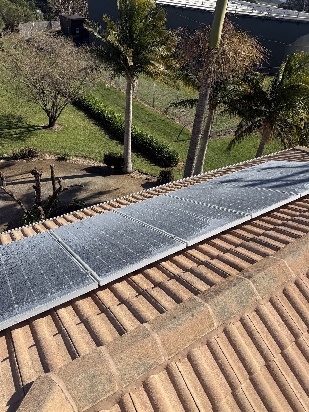 Solar panels before cleaning at a Shellharbour property, showing dirt and build-up