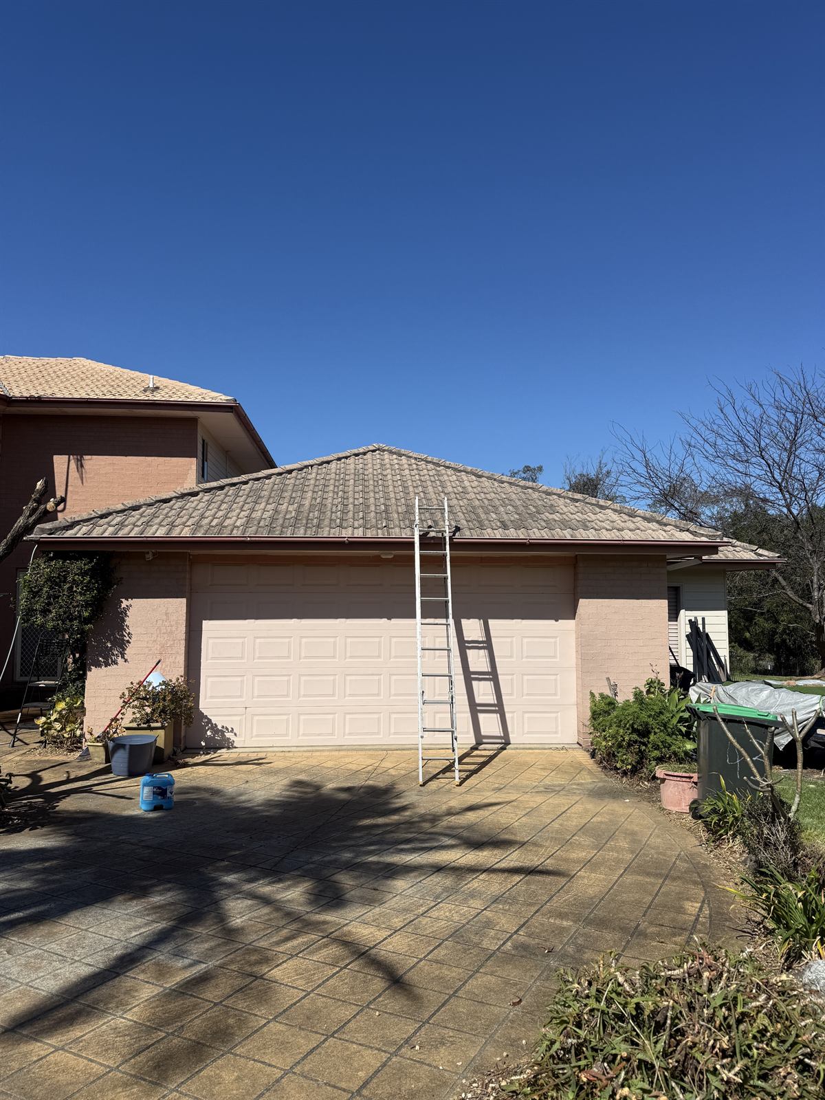 Tile roof before cleaning, front view, at a Shellharbour property showing visible dirt and staining
