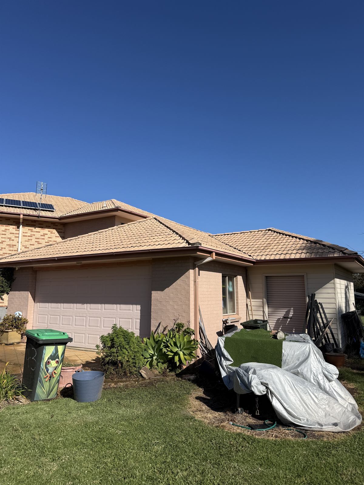 Tile roof after cleaning, side view, at a Shellharbour property showing a cleaner tiled surface