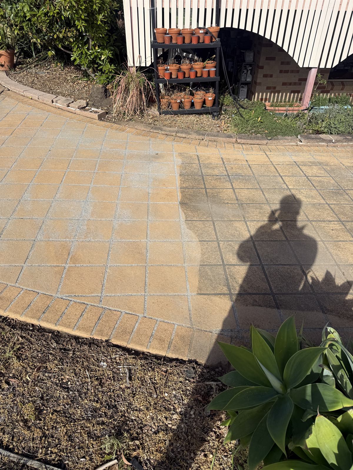 Paving cleaning in progress at a Shellharbour property, showing a visible clean section