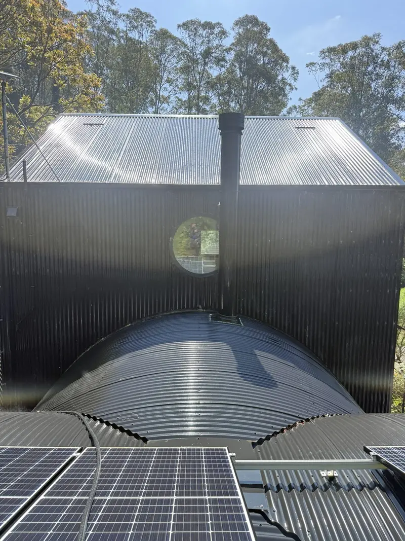 Black corrugated walls and curved roof after cleaning in Jamberoo