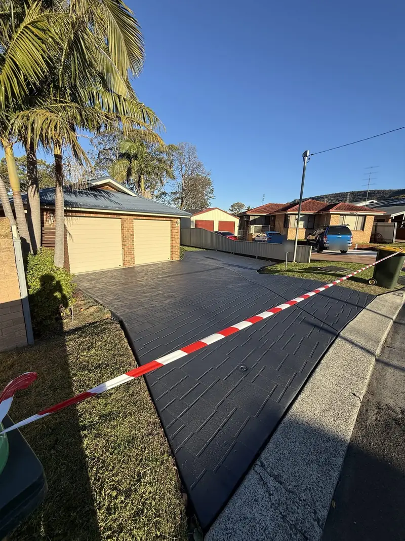 Stamped concrete driveway after dark grey colour sealing