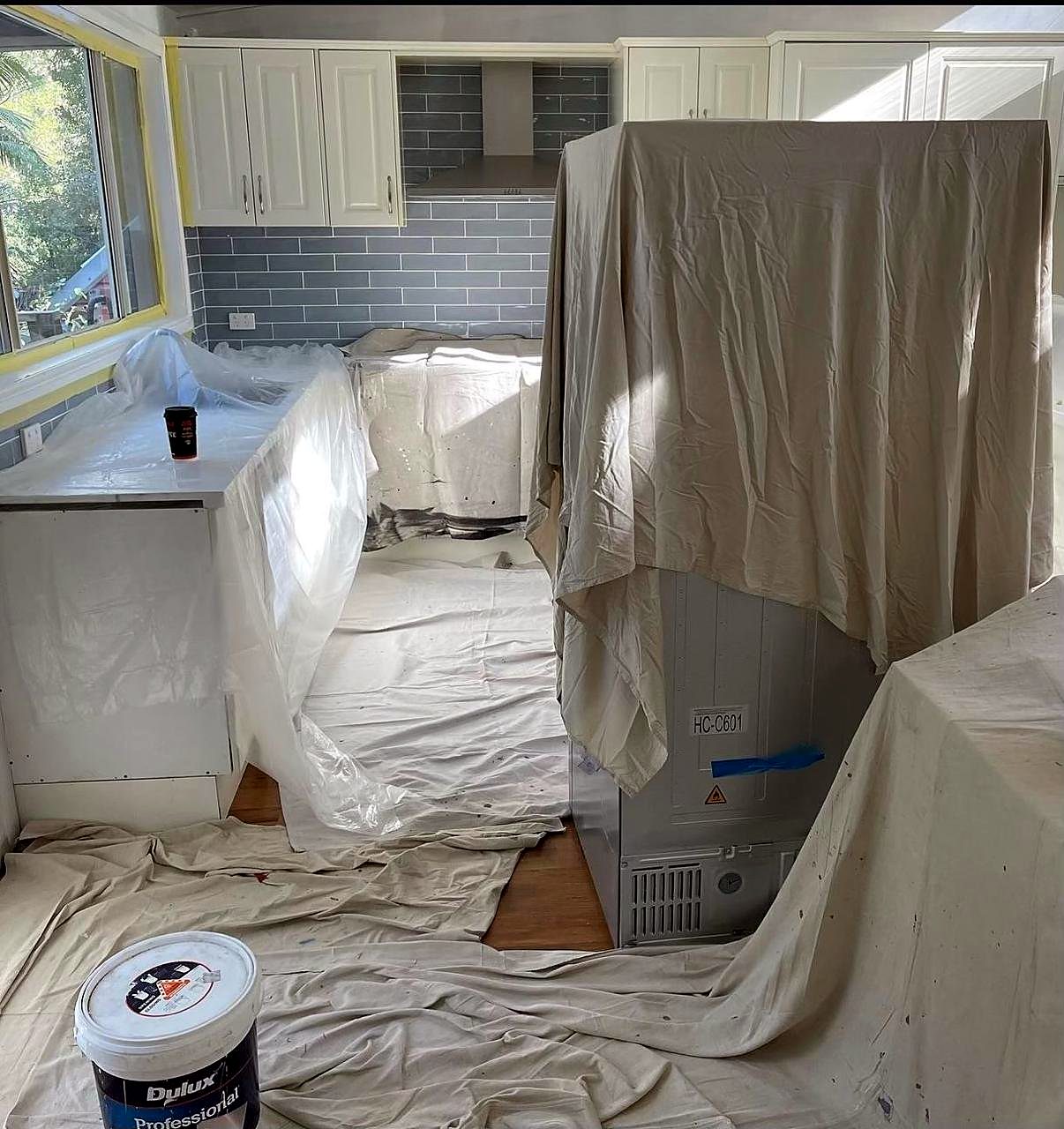 Kitchen fully covered with drop sheets and plastic before painting