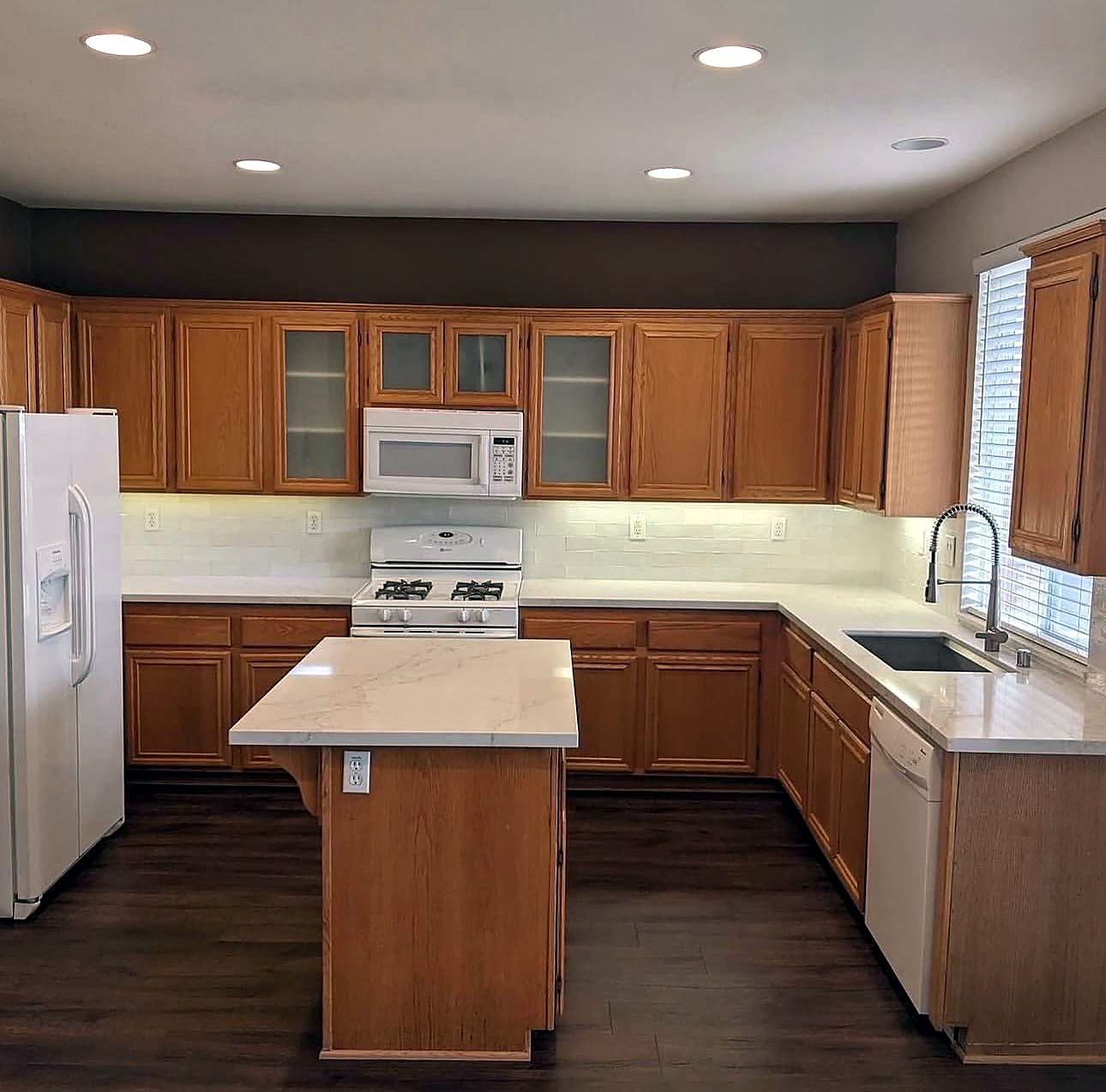 Kitchen with dated orange timber cabinets
