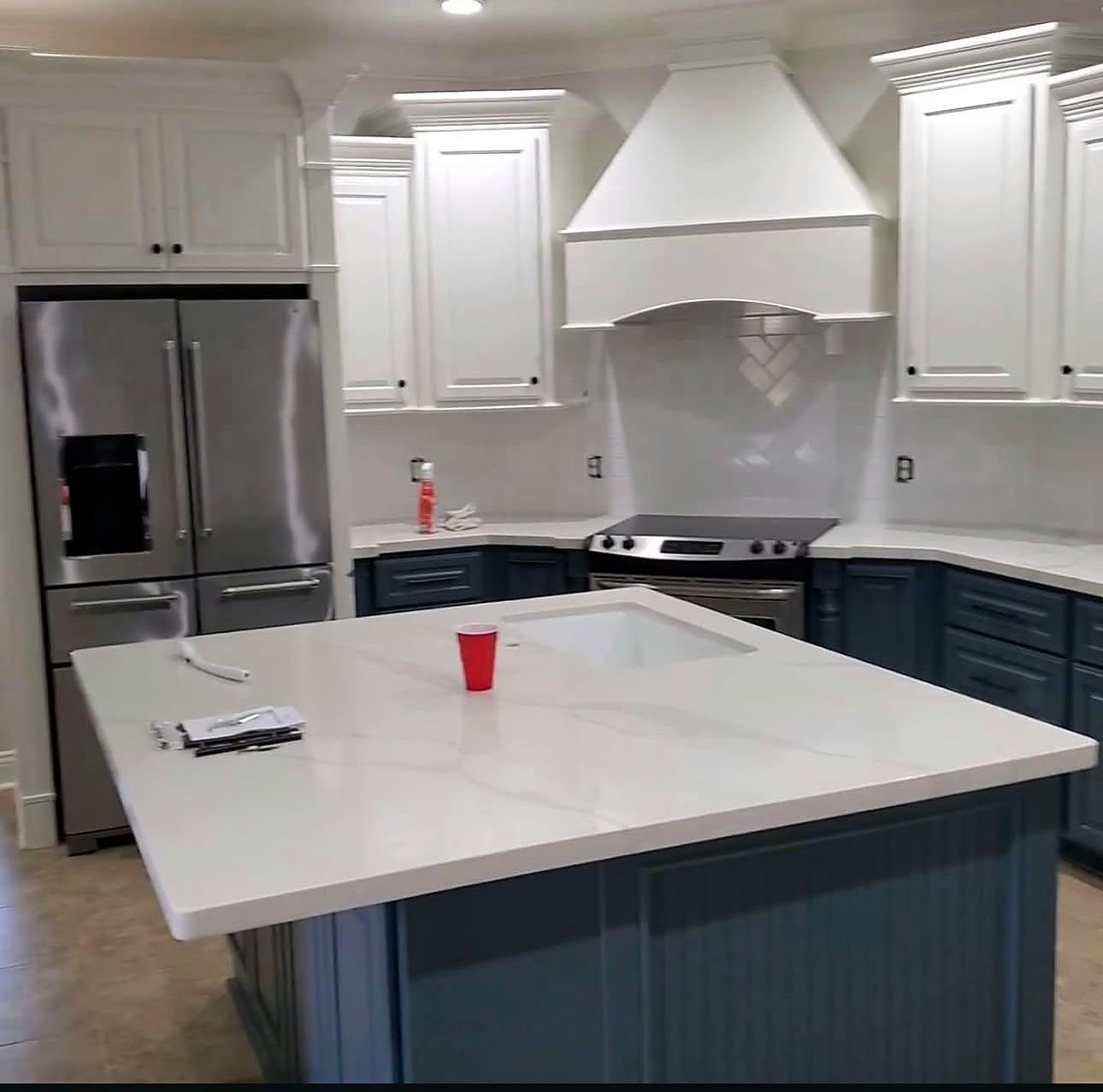 White kitchen with navy island