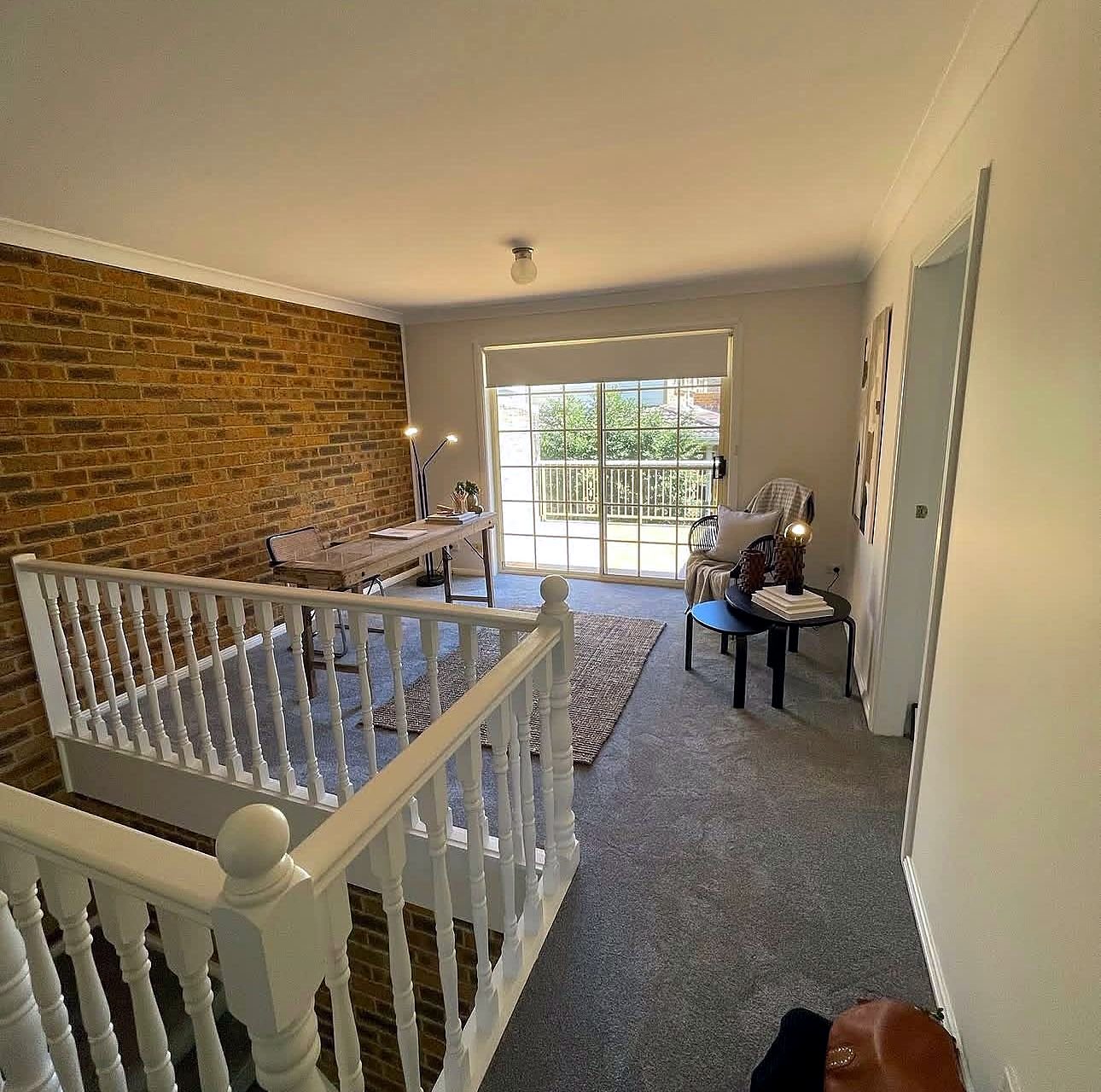 Living room with a brick feature wall and fresh paint