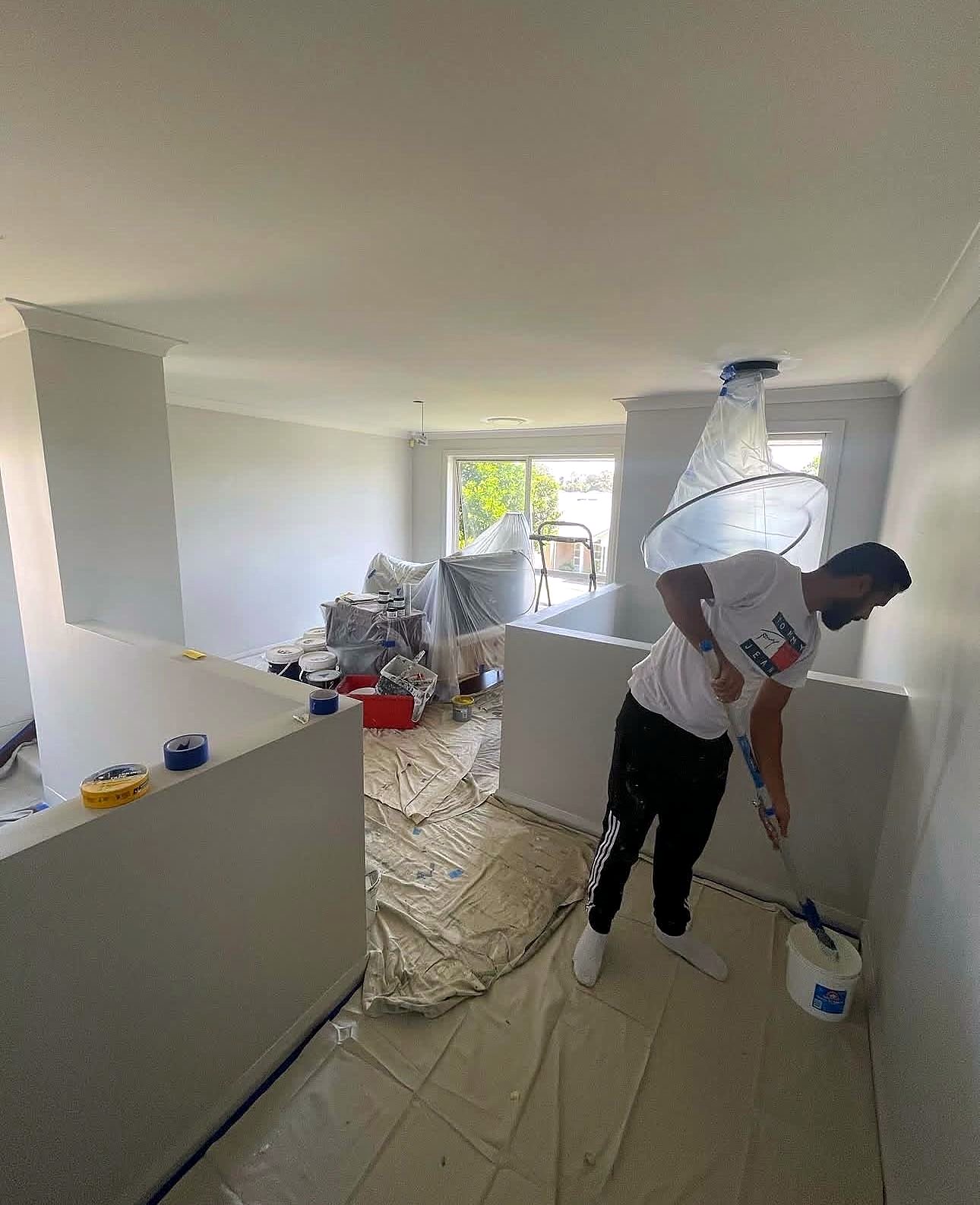 Painter rolling an interior wall