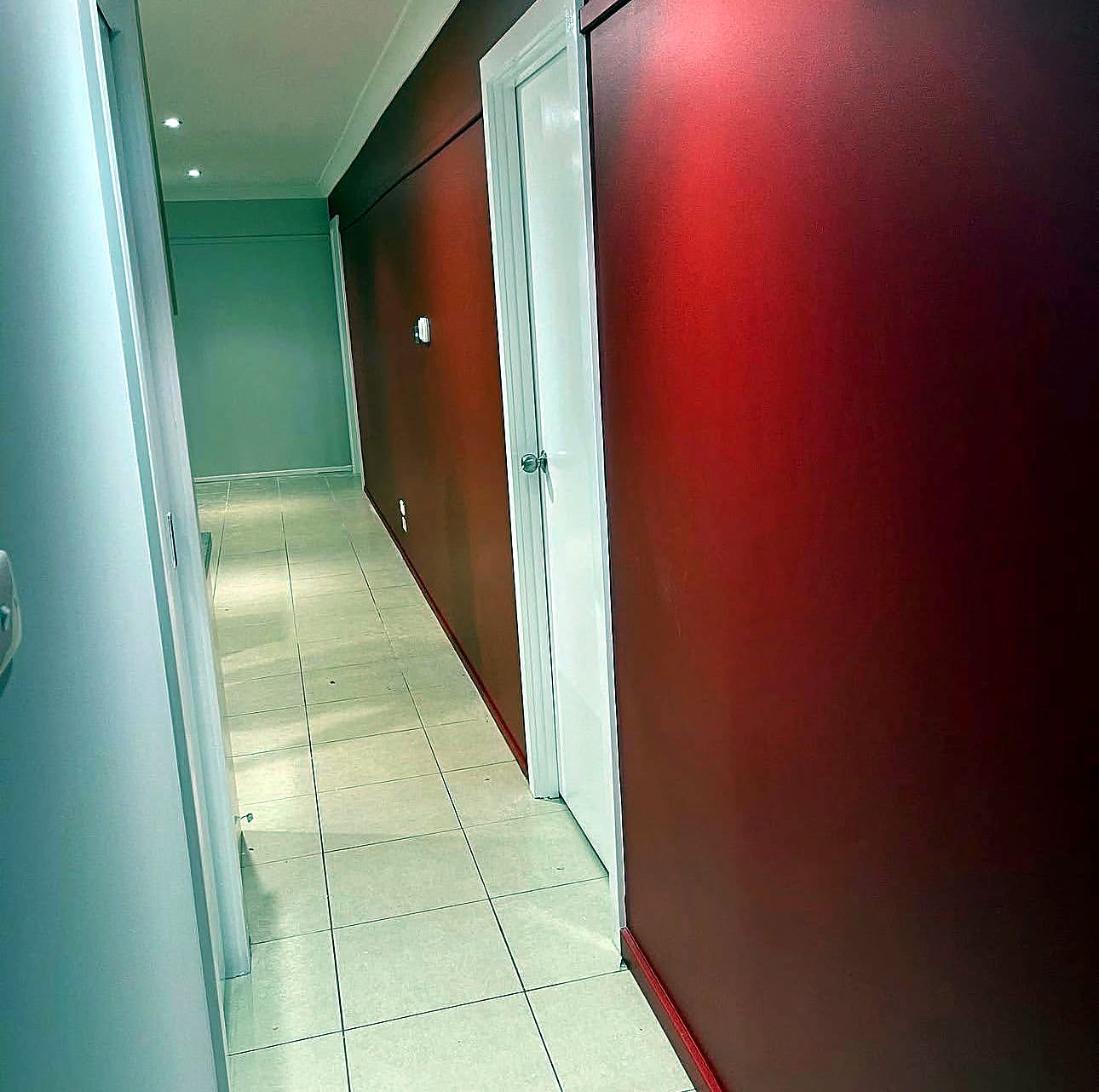 Bold red feature wall in a hallway