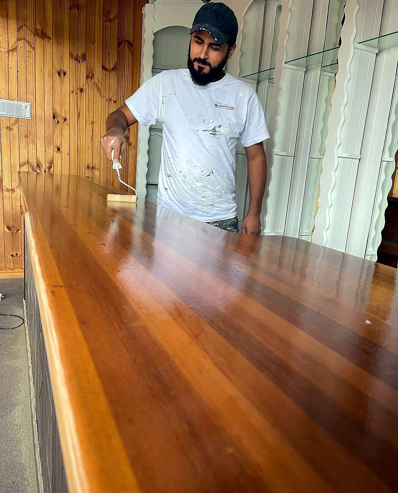 Painter sealing a timber benchtop