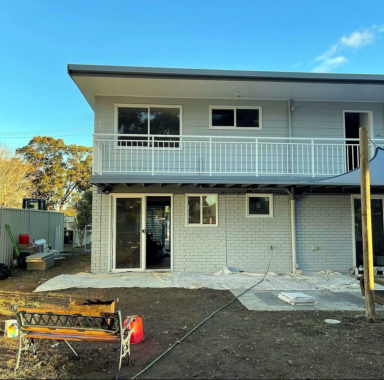 Two-storey home during an exterior repaint