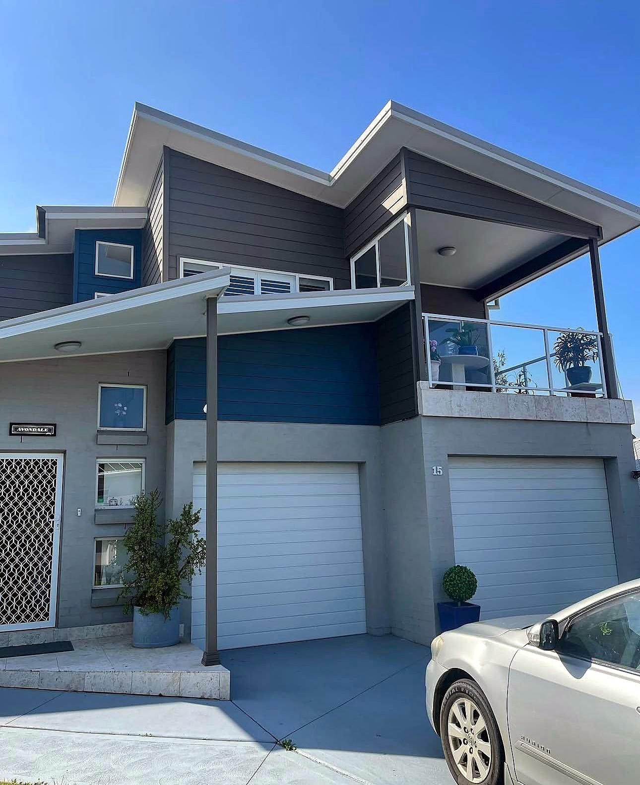 Two-storey townhouse painted grey and navy