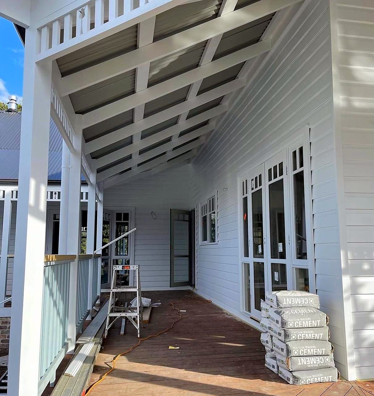 Verandah ceiling and weatherboards being painted white