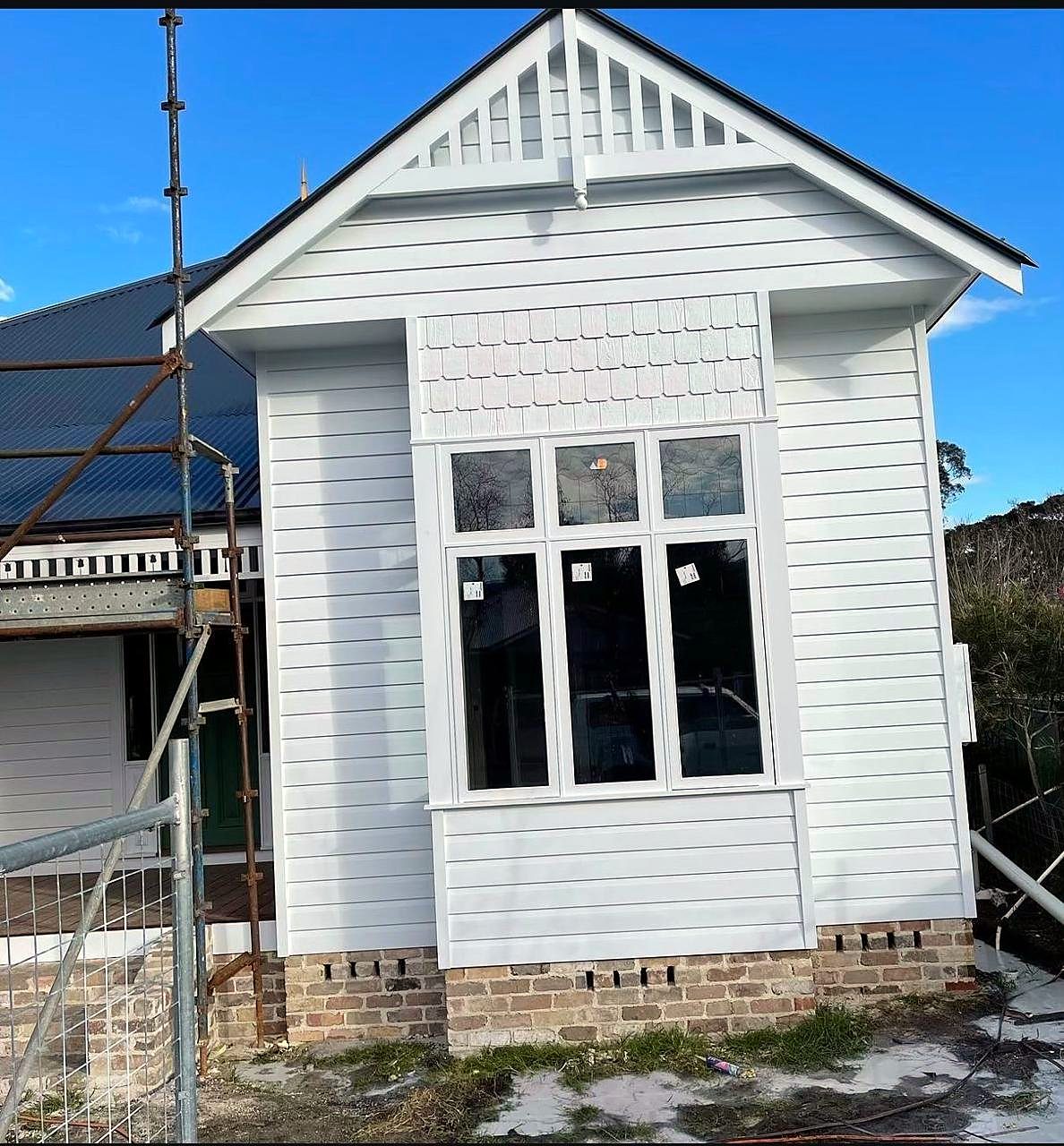 White weatherboard cottage after an exterior repaint