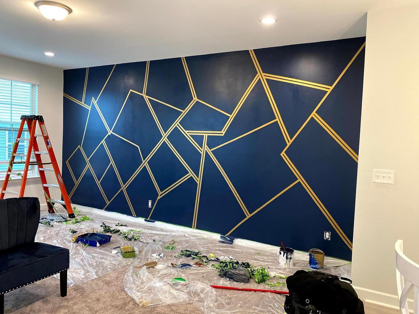 Navy feature wall with gold geometric lines