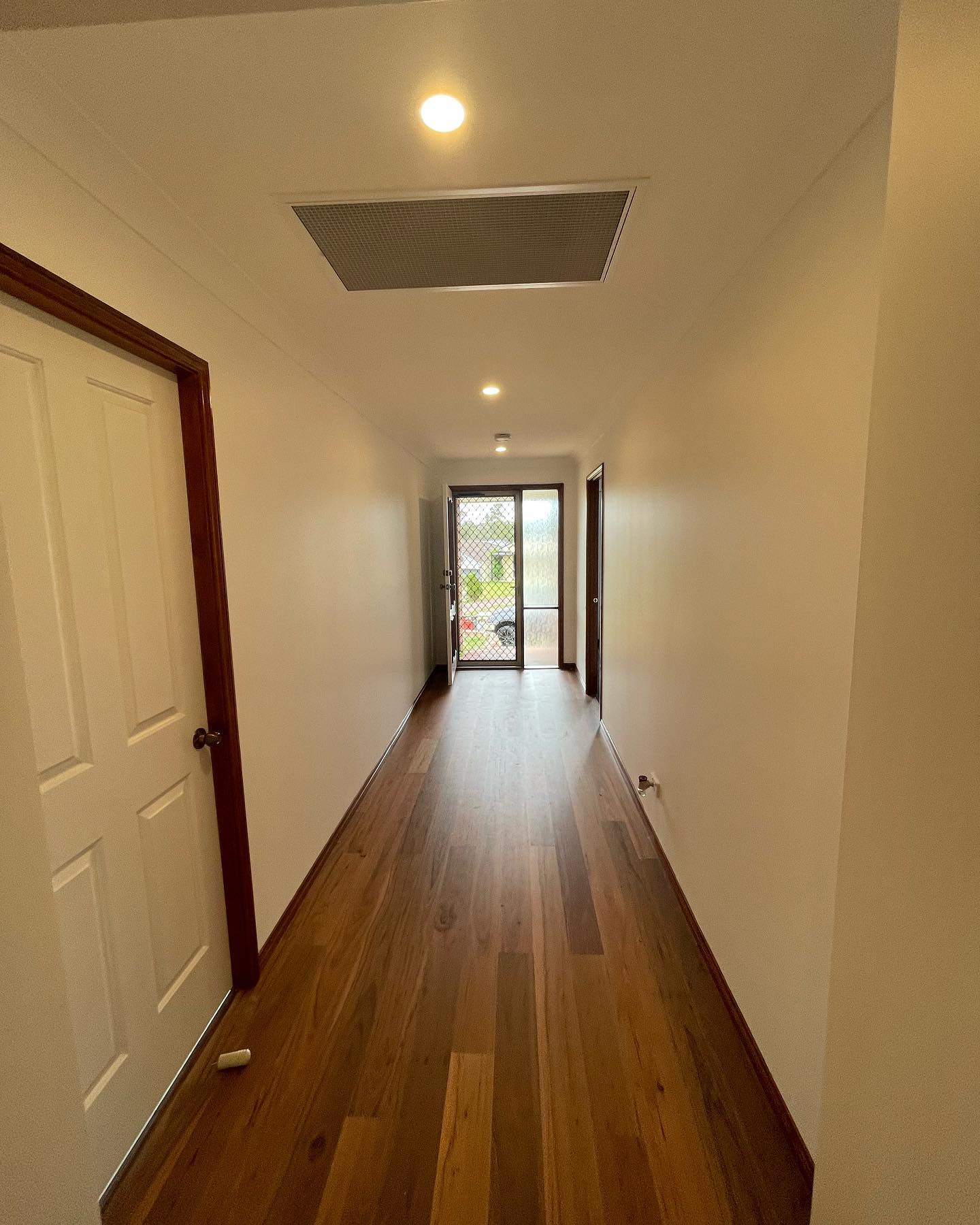 Long hallway freshly painted warm white