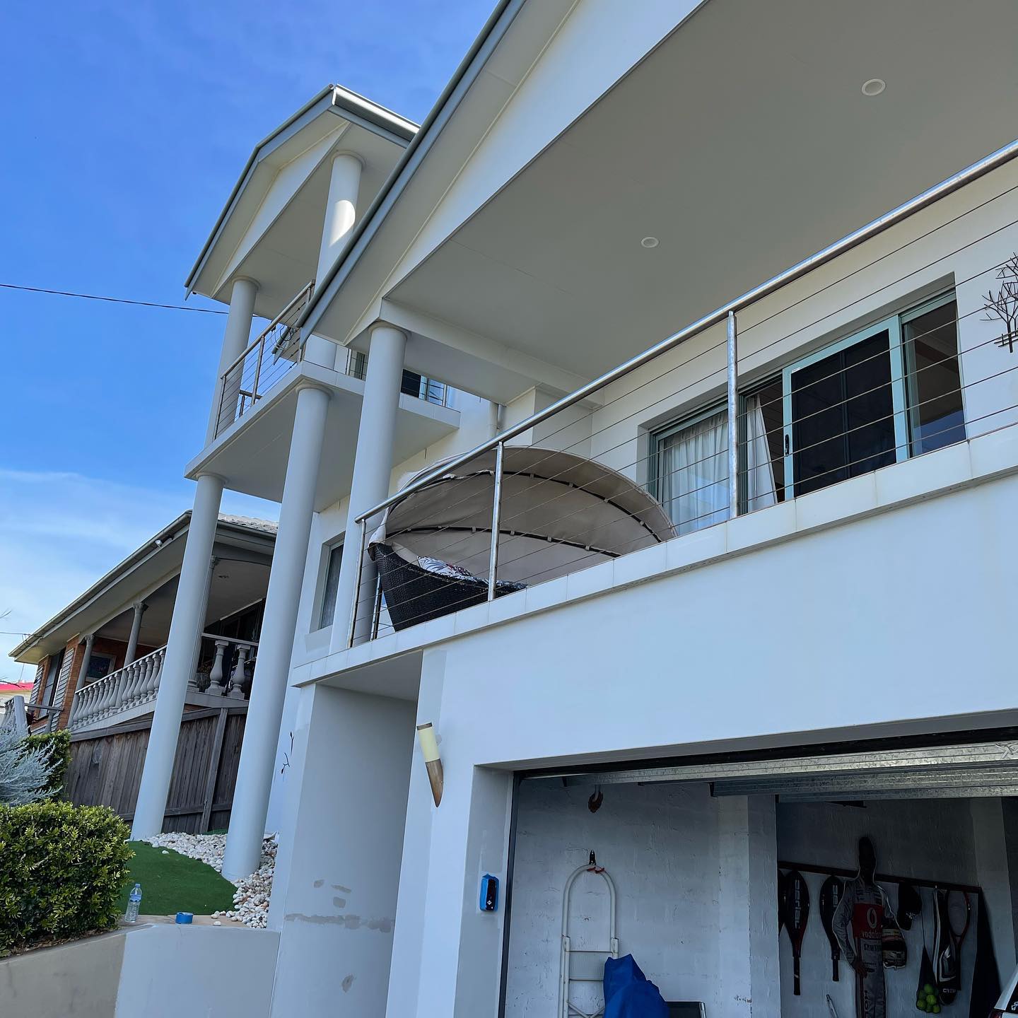 Two-storey home with a white painted verandah