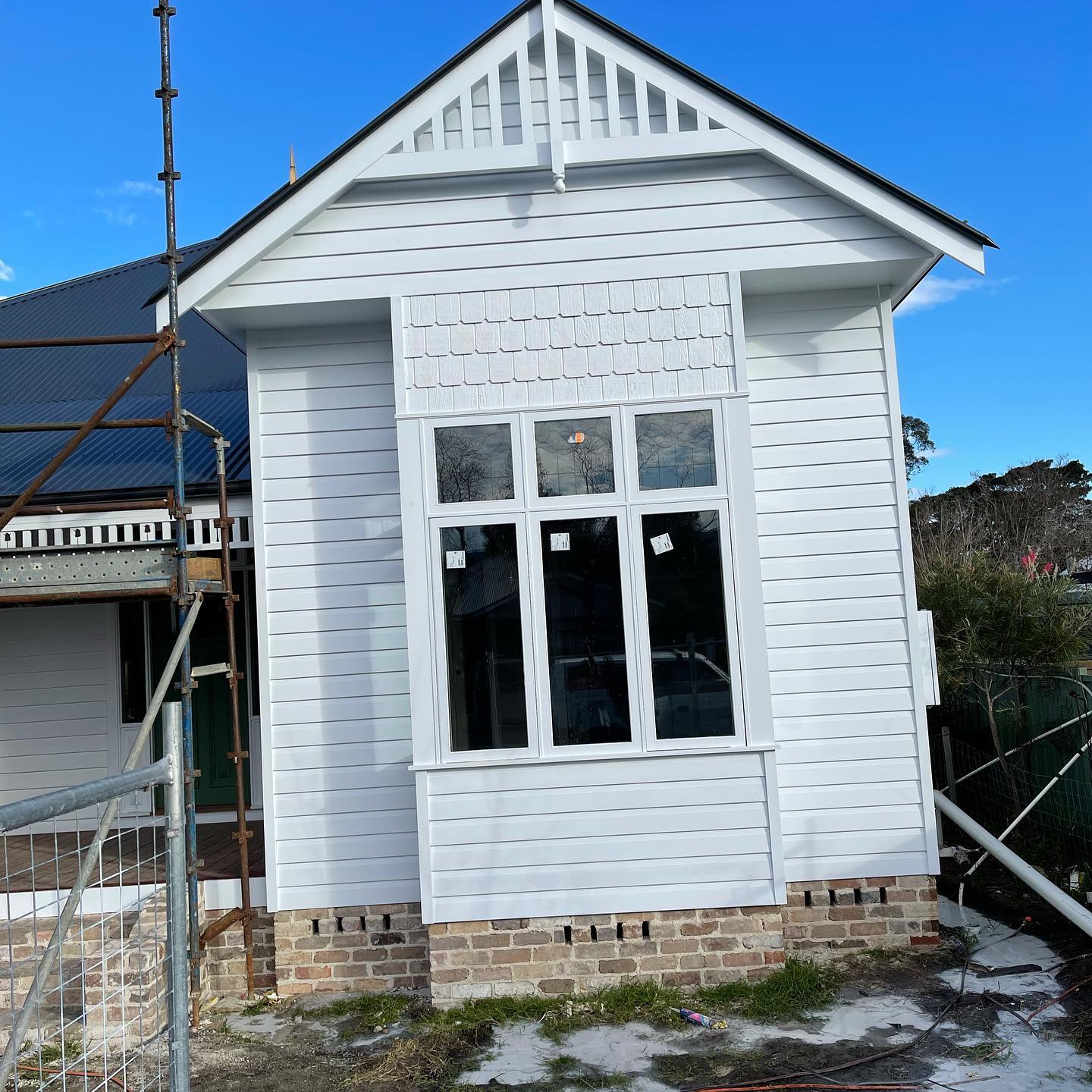 Weatherboard cottage gable freshly painted white