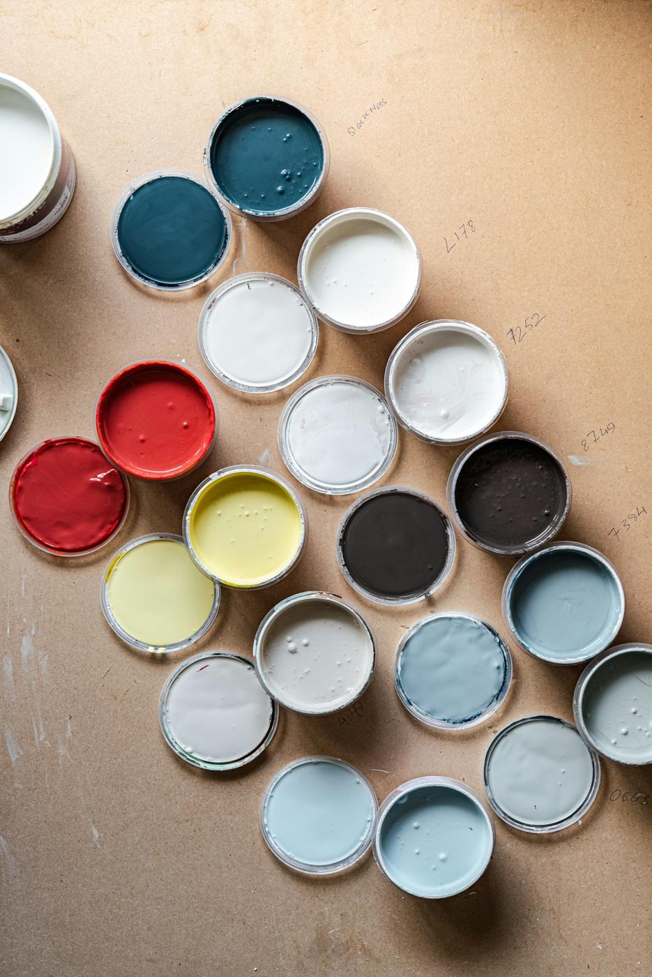 Open paint tins in a range of colours