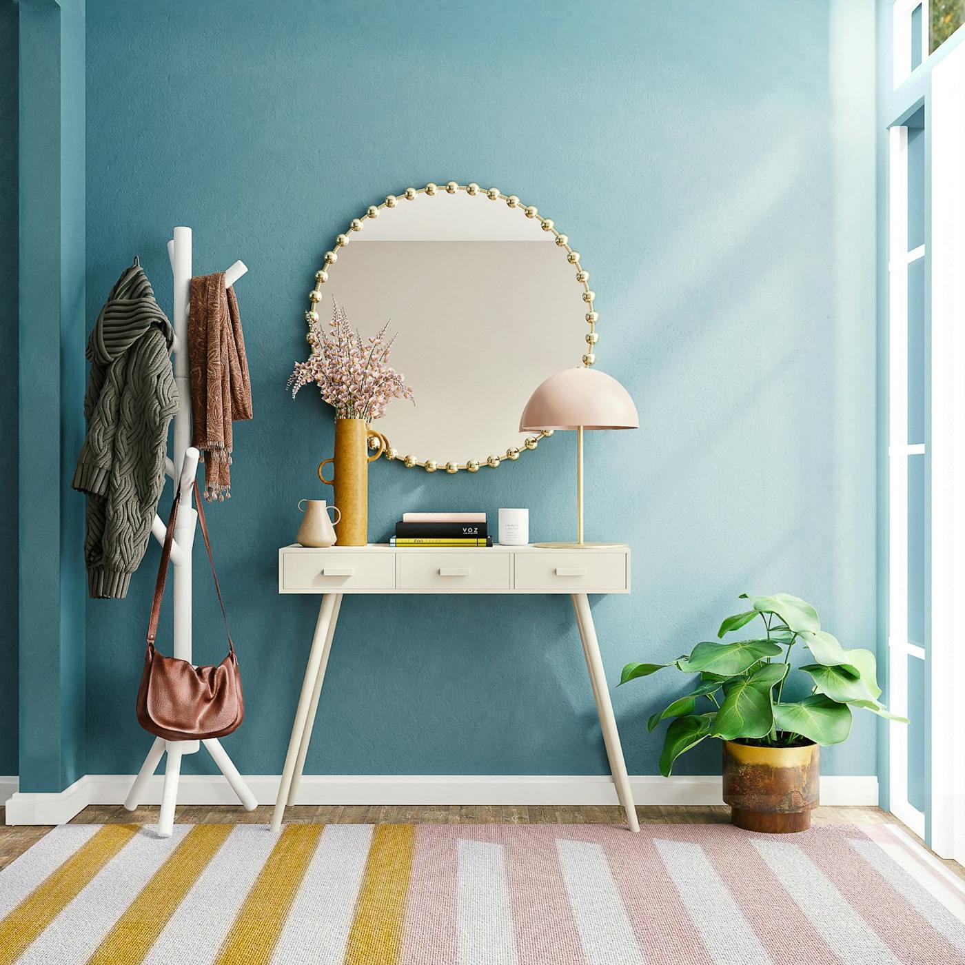 Teal feature wall styled with a mirror and plants