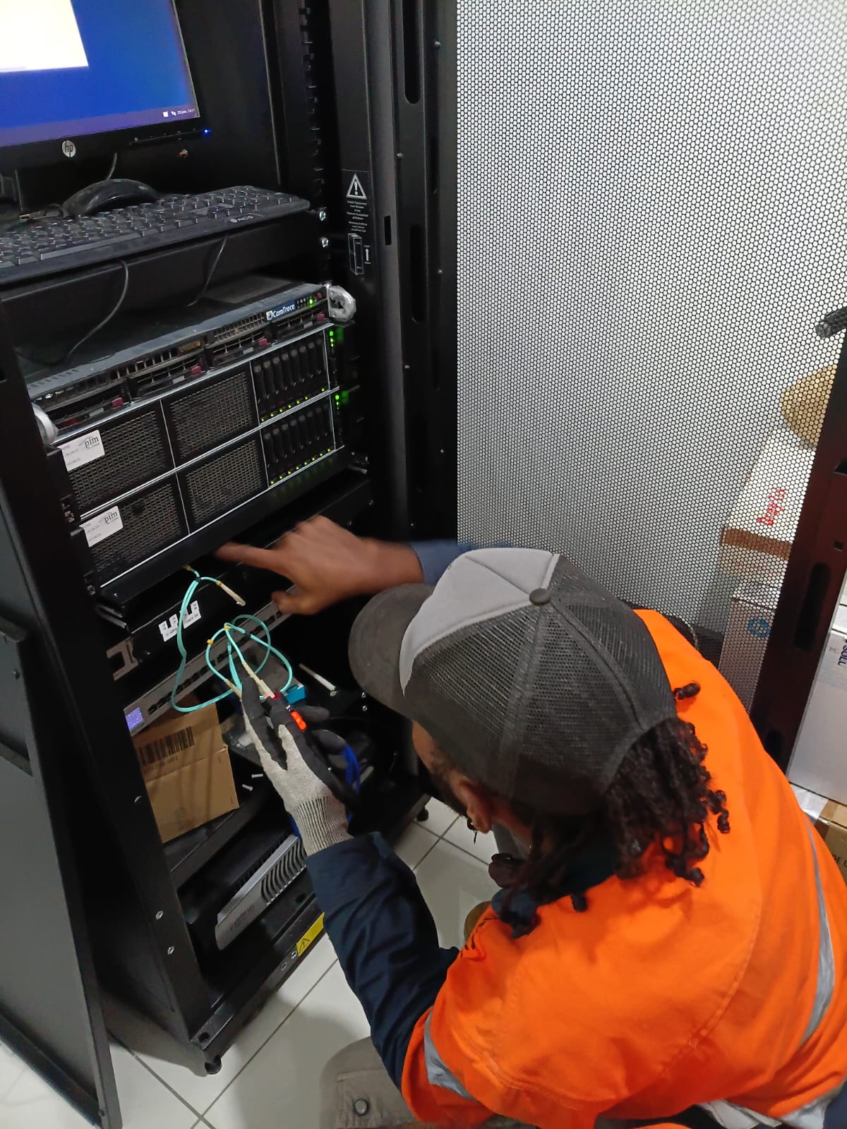 ODC technician patching a fibre uplink into a network switch inside a client's server rack in Port Vila, Vanuatu
