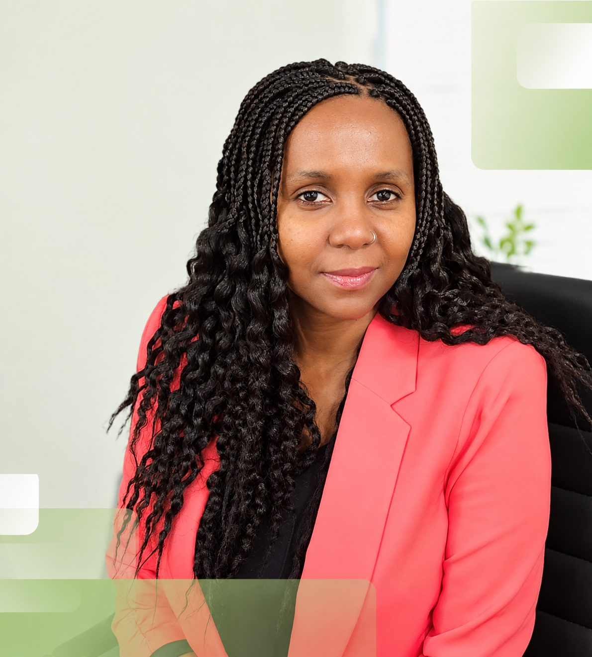 A Professional Woman in a Coral Blazer Smiling in Wellness Center Office