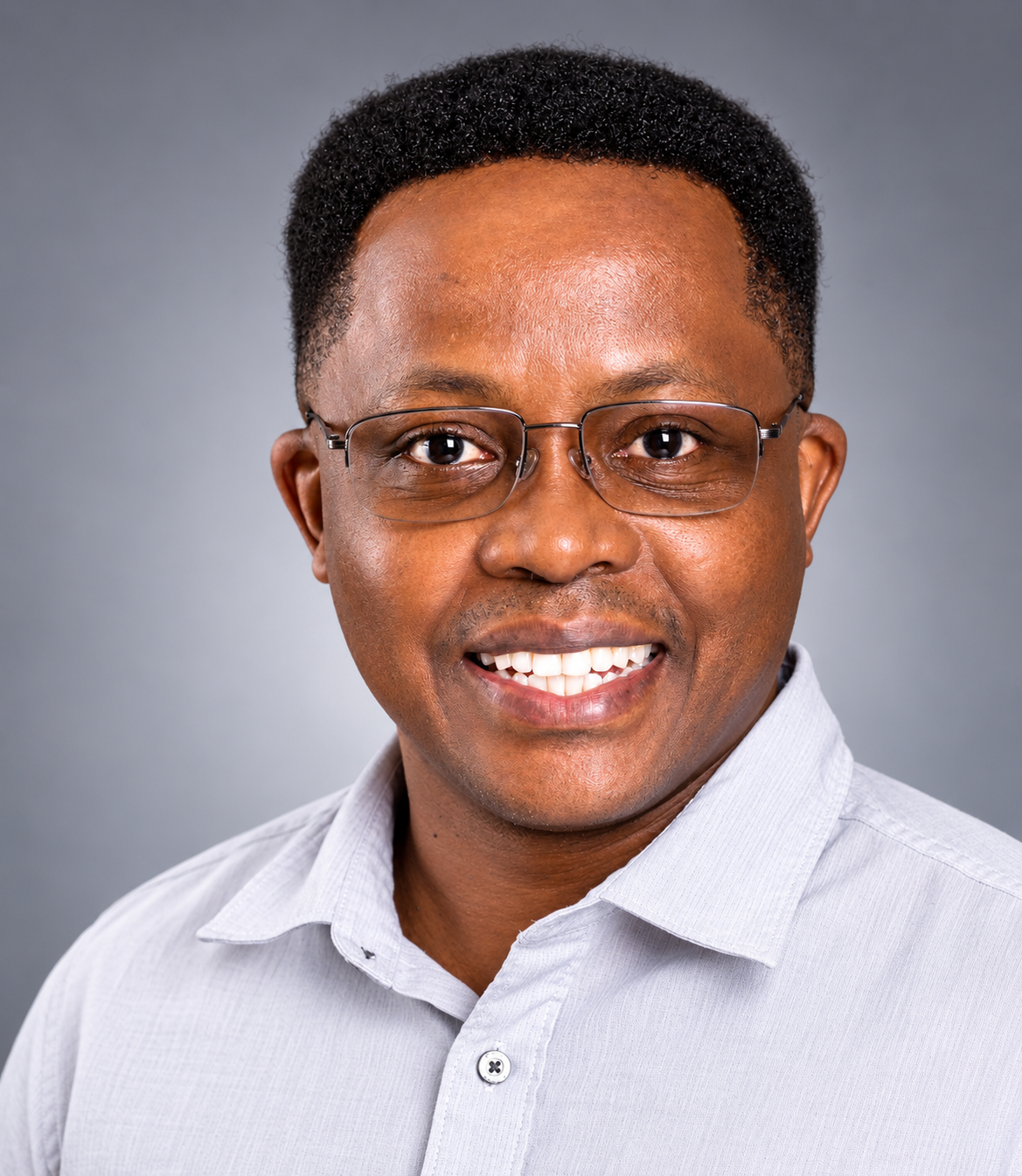 Smiling Man in Glasses and Light Shirt with Neutral Background