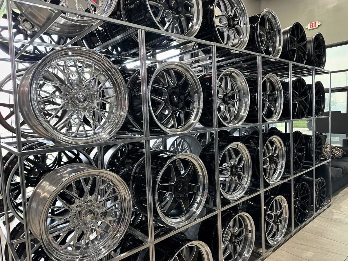 Wall of chrome wheels on display at the shop.