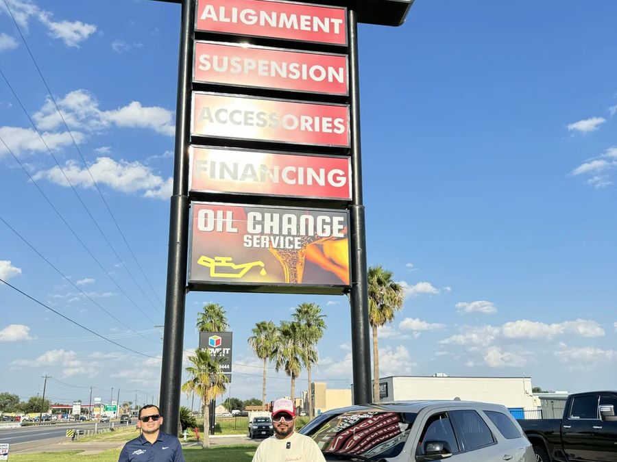 Service board at the shop entrance: alignment, suspension, accessories, financing.